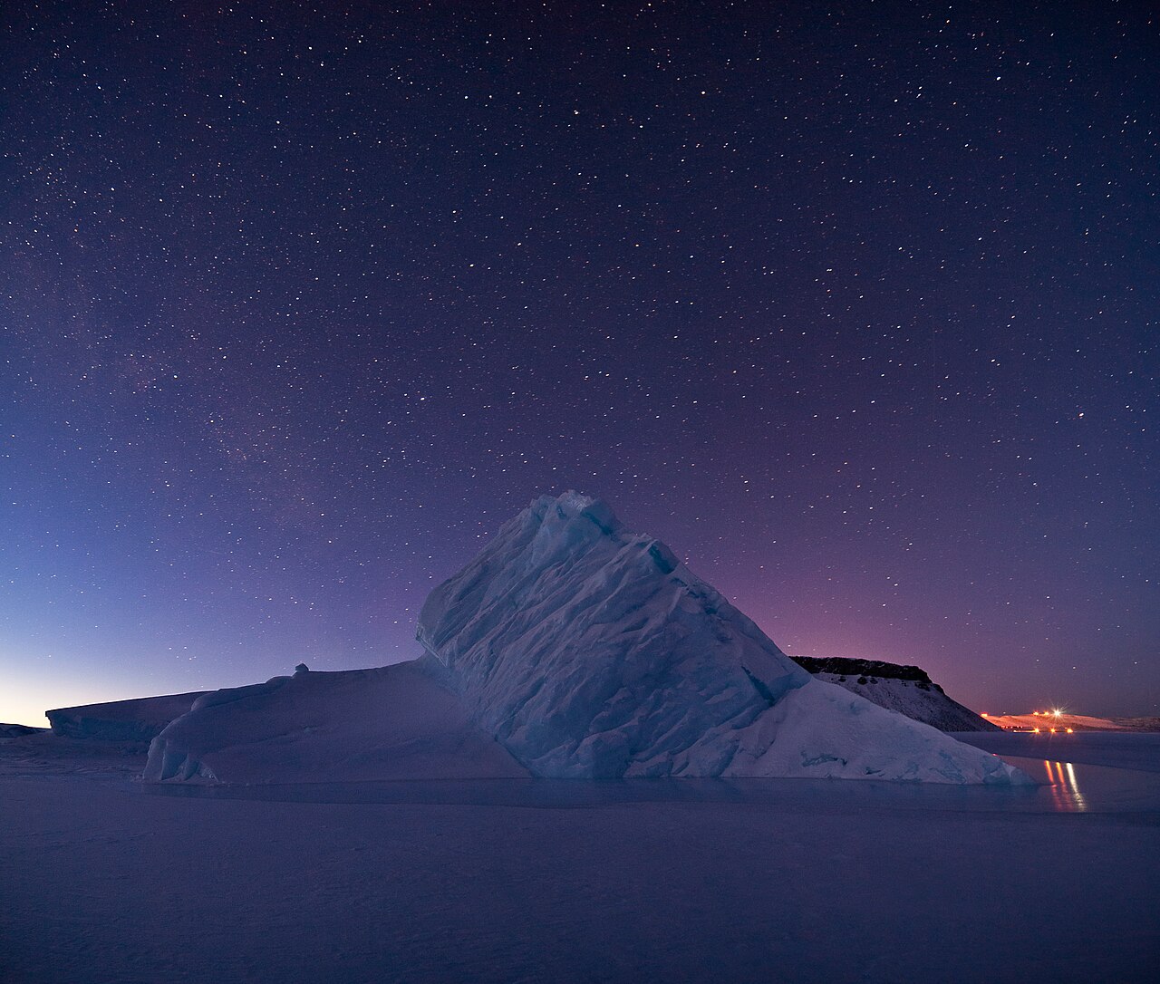 An iceberg in North Star Bay, Greenland, most of its bulk hidden beneath the water.