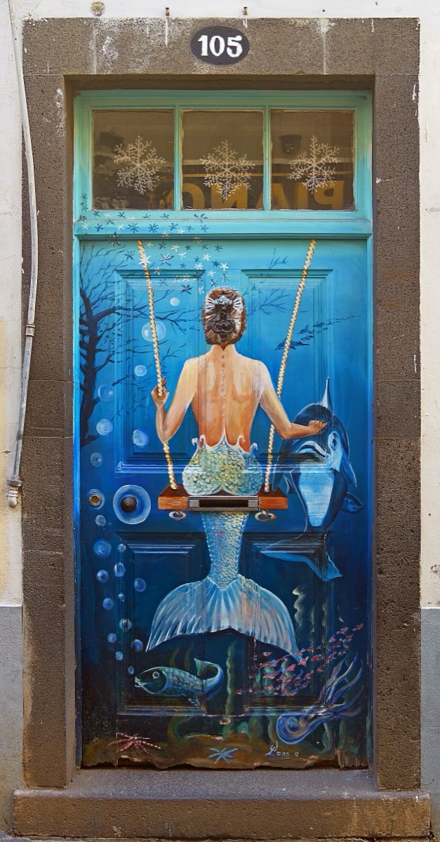 A door in Funchal, Madeira, painted with a mermaid, decoration standing in for an opening that is not actually there.
