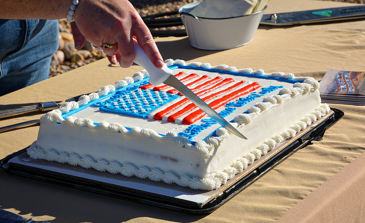 A cake being sliced into separate pieces.