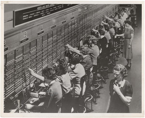 Operators connecting calls at a Bell System telephone switchboard in 1943.
